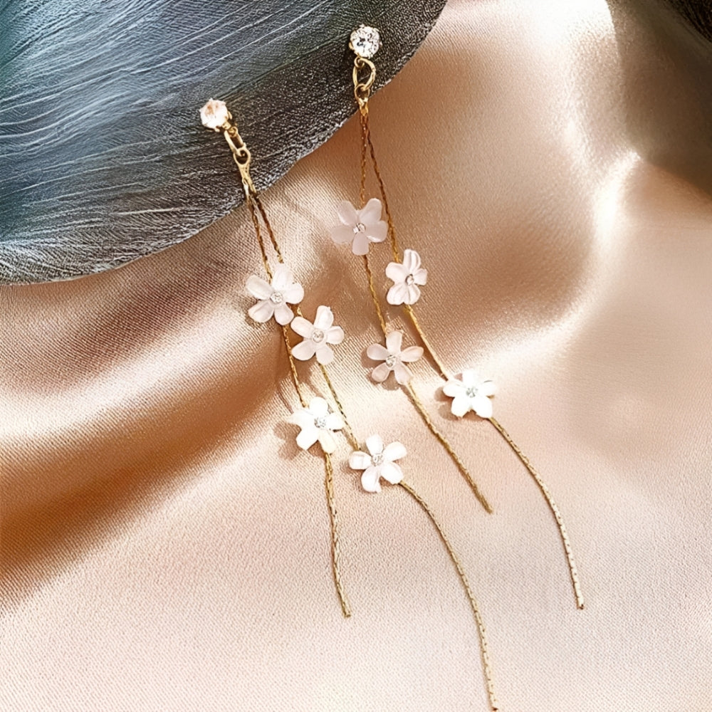 Ohrringe mit weißen Blüten und goldenen Fäden